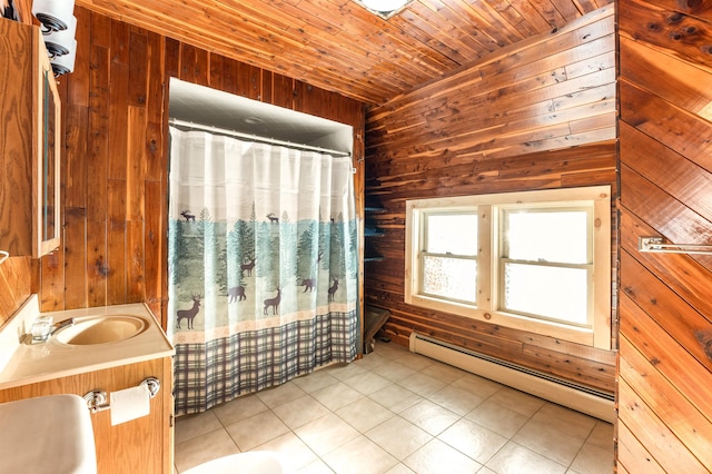 bathroom with vanity, a baseboard heating unit, wooden walls, and wooden ceiling