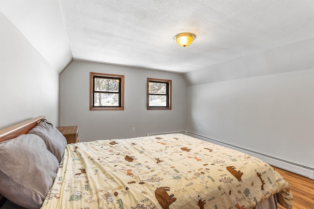 bedroom with lofted ceiling, hardwood / wood-style floors, and a textured ceiling