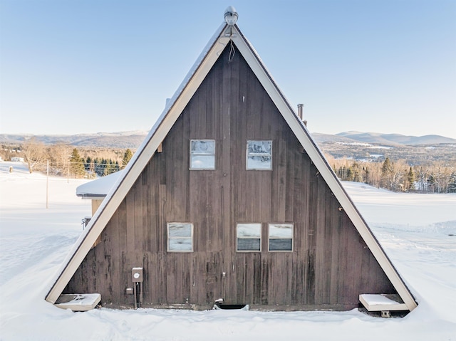 view of snowy exterior featuring a mountain view