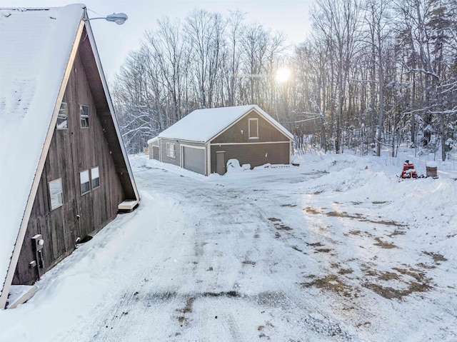 exterior space featuring a garage and an outdoor structure