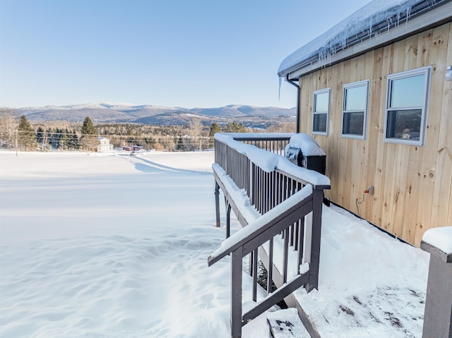 snow covered deck featuring a mountain view