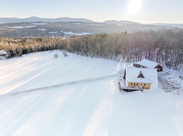 snowy aerial view featuring a mountain view