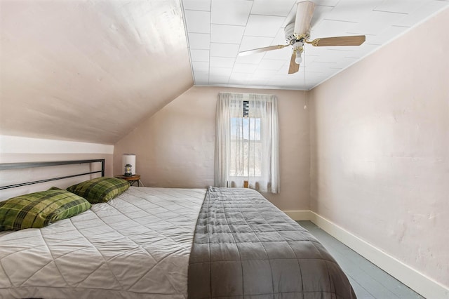 bedroom with lofted ceiling, ceiling fan, and hardwood / wood-style flooring