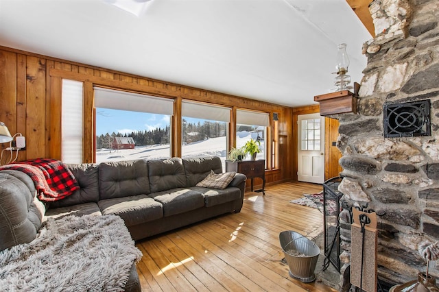 living room featuring light hardwood / wood-style floors and wooden walls