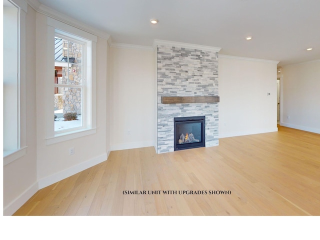 unfurnished living room featuring ornamental molding, a tile fireplace, and a wealth of natural light