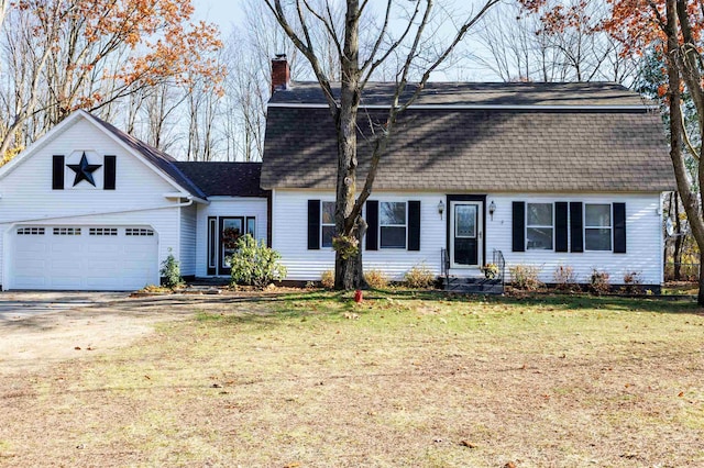 colonial inspired home with a garage, driveway, a shingled roof, a gambrel roof, and a front lawn