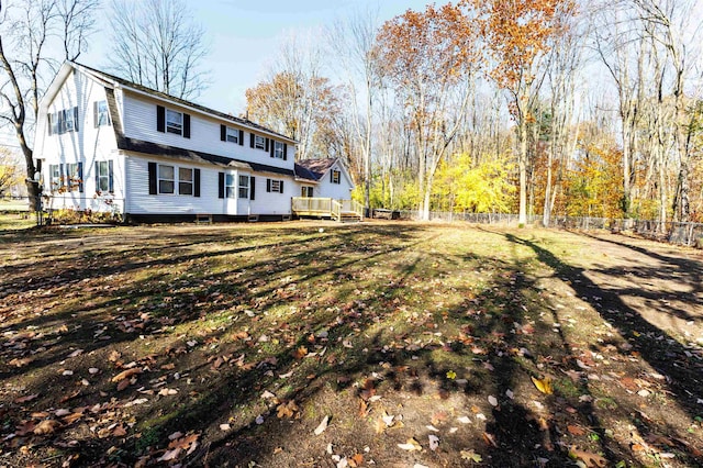 rear view of property with a yard and a deck