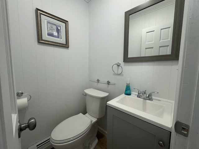 bathroom featuring vanity, toilet, and baseboard heating