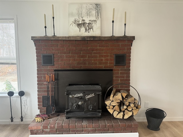 details featuring wood-type flooring and a wood stove