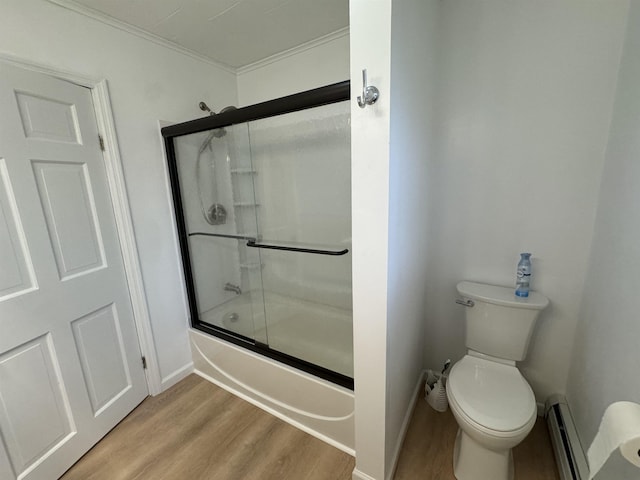 bathroom with toilet, crown molding, wood-type flooring, bath / shower combo with glass door, and baseboard heating