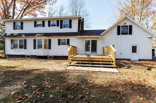 rear view of property featuring a wooden deck