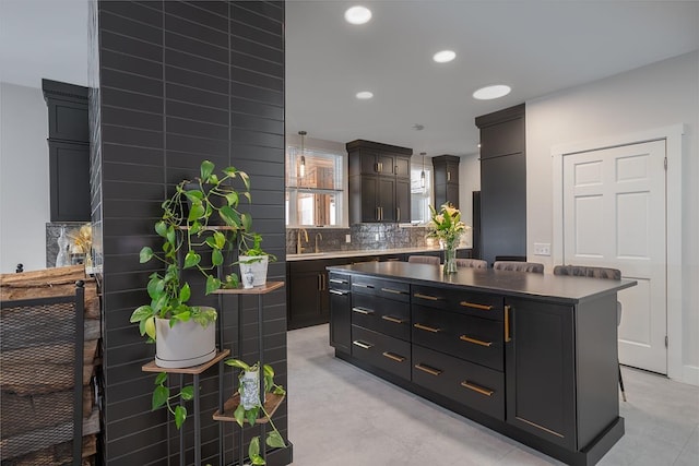 kitchen featuring a center island, sink, and backsplash