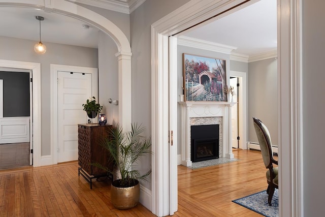 corridor featuring hardwood / wood-style flooring and ornamental molding