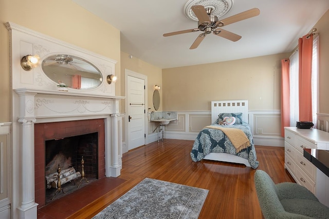 bedroom with dark hardwood / wood-style floors and ceiling fan