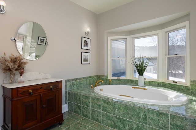 bathroom featuring tile patterned flooring and a relaxing tiled tub