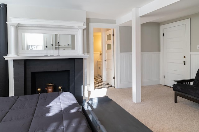 bedroom featuring carpet flooring and a brick fireplace