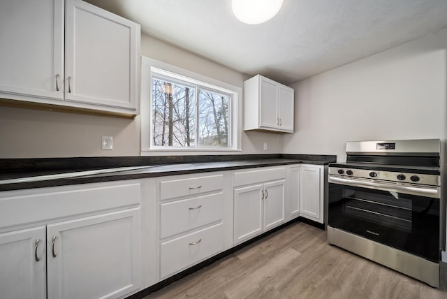 kitchen featuring electric range, light hardwood / wood-style flooring, and white cabinets