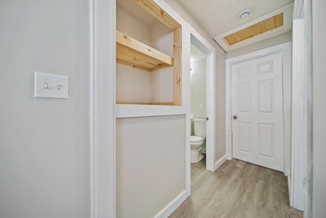 bathroom with hardwood / wood-style flooring and toilet