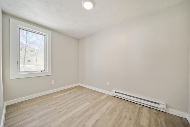 spare room with light hardwood / wood-style flooring and baseboard heating