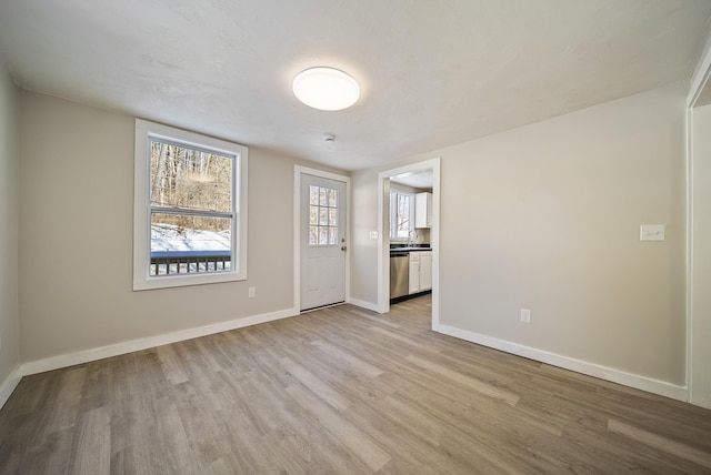 spare room featuring light hardwood / wood-style floors