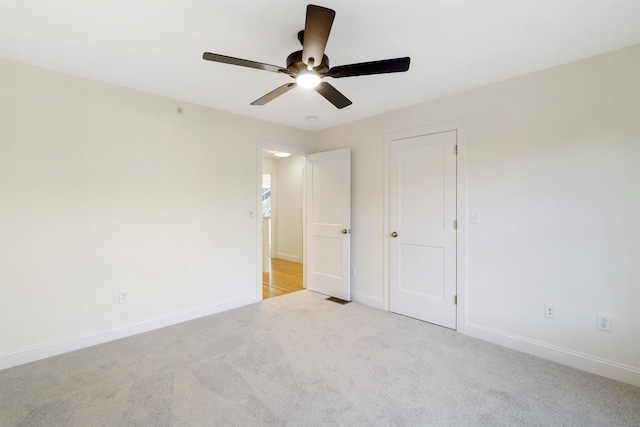 unfurnished bedroom featuring light carpet and ceiling fan