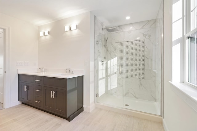 bathroom featuring vanity, hardwood / wood-style floors, and walk in shower