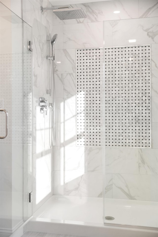 bathroom with a shower with shower door