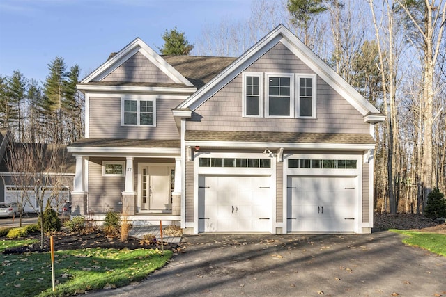 craftsman inspired home with a garage and a porch