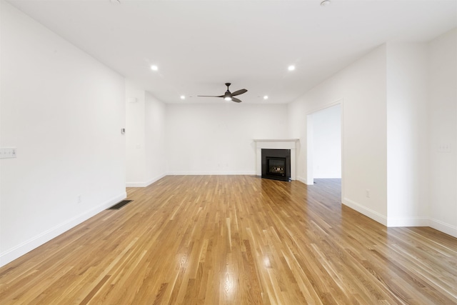 unfurnished living room featuring ceiling fan and light hardwood / wood-style flooring