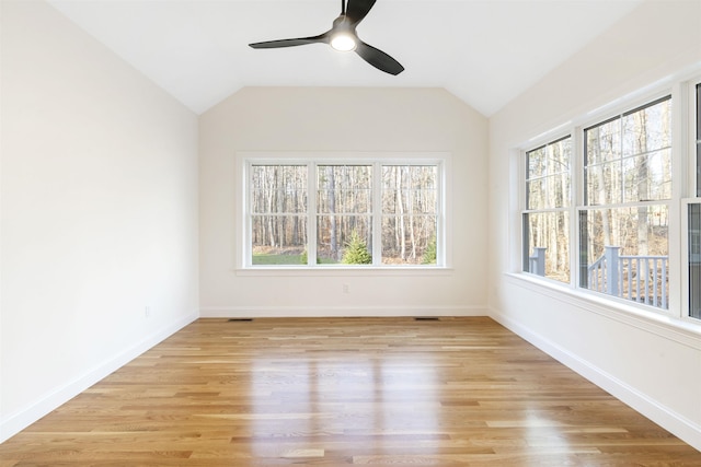 unfurnished sunroom featuring ceiling fan and vaulted ceiling