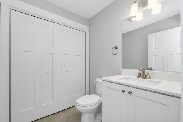 bathroom with vanity, tile patterned floors, and toilet