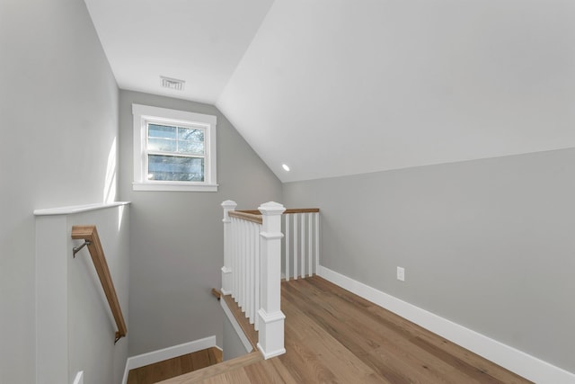 bonus room featuring lofted ceiling and light hardwood / wood-style flooring