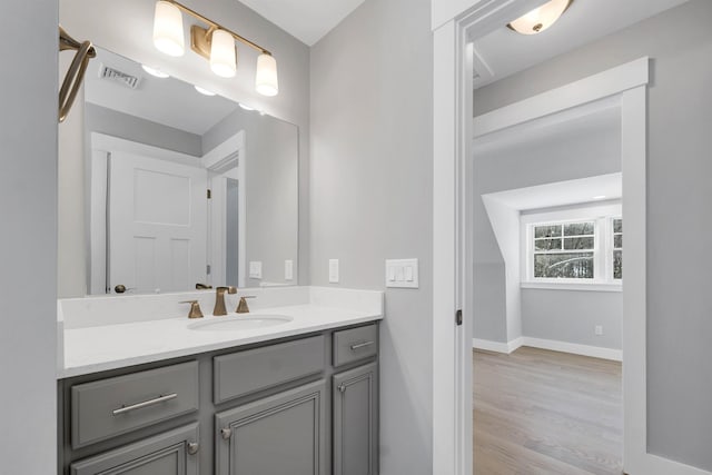 bathroom with vanity and hardwood / wood-style floors