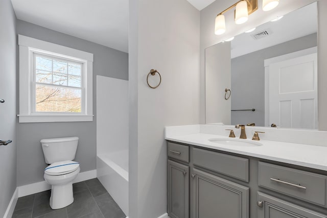 bathroom with vanity, tile patterned flooring, and toilet