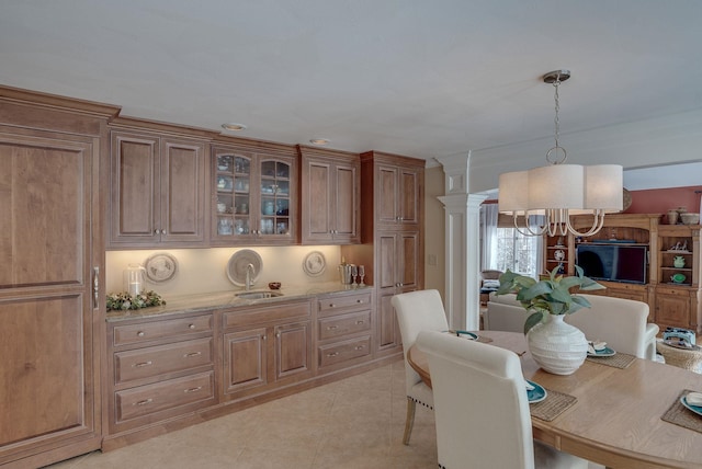 tiled dining space featuring a notable chandelier and decorative columns