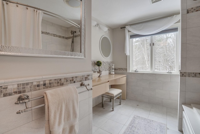 bathroom with tile patterned flooring, tile walls, and a shower with shower curtain