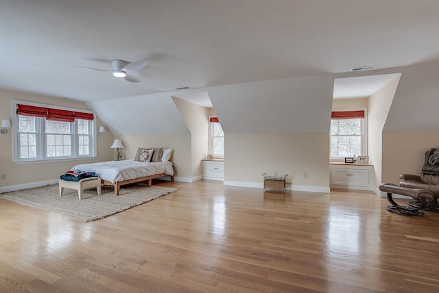 bedroom featuring ceiling fan, lofted ceiling, and light hardwood / wood-style floors