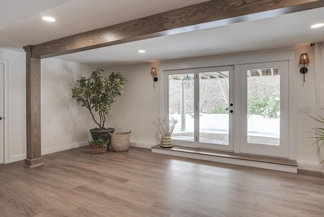 doorway to outside with light hardwood / wood-style flooring, french doors, beamed ceiling, and ornate columns