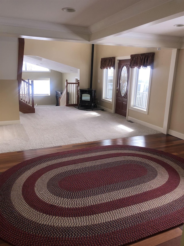 foyer entrance with a healthy amount of sunlight, baseboards, and wood finished floors