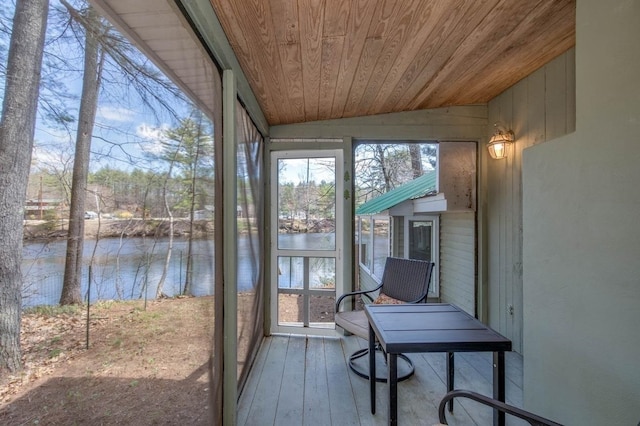 sunroom / solarium featuring vaulted ceiling, a water view, and wood ceiling