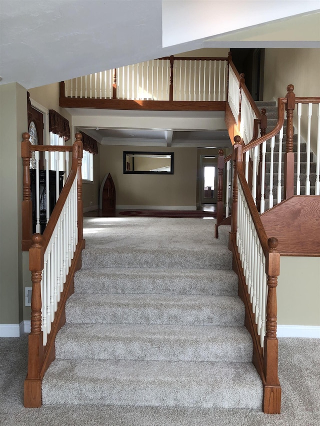 stairs with baseboards and carpet flooring