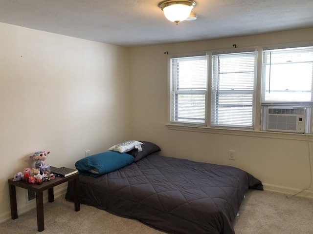 carpeted bedroom with cooling unit and baseboards