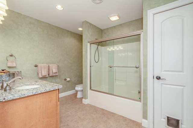 bathroom with enclosed tub / shower combo, toilet, vanity, baseboards, and tile patterned floors