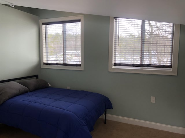 carpeted bedroom with baseboards