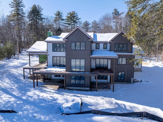 view of snow covered rear of property