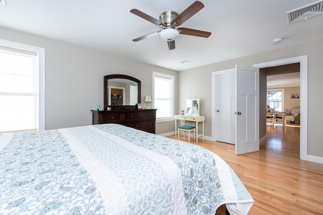 bedroom with light hardwood / wood-style floors and ceiling fan