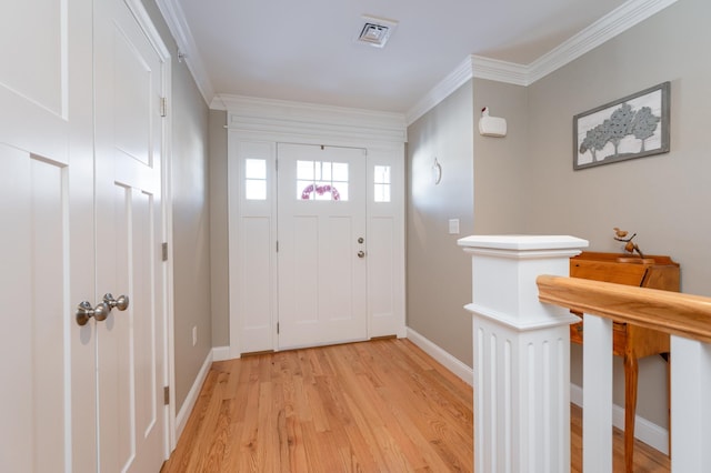 foyer featuring crown molding and light hardwood / wood-style flooring