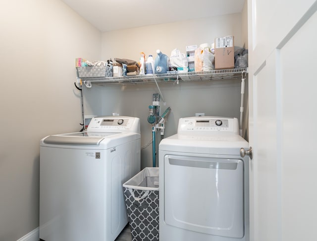 clothes washing area with independent washer and dryer