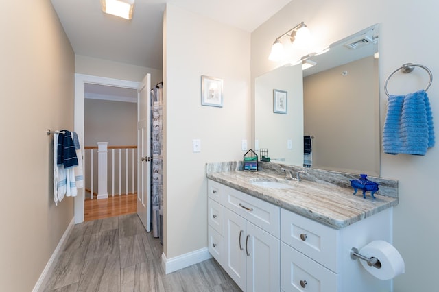 bathroom with vanity and hardwood / wood-style floors