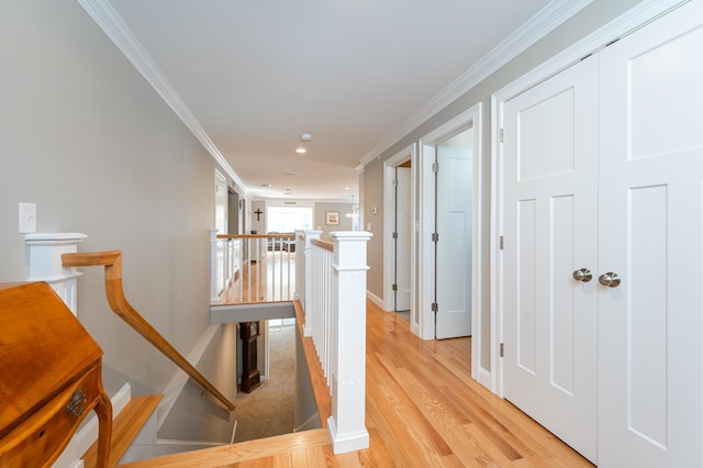 corridor featuring crown molding and light hardwood / wood-style floors